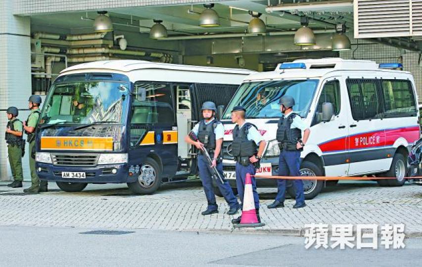 ■文子星被指具逃獄風險,警方荷槍實彈在囚車附近戒備。黃耀興攝
■文子星被指具逃獄風險,警方荷槍實彈在囚車附近戒備。黃耀興攝