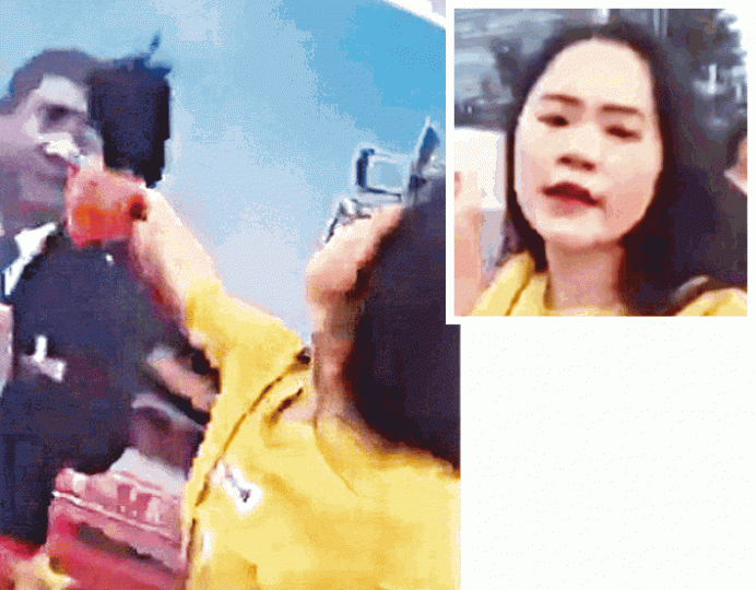 ■上海一名女子昨早直播在海航大廈前向習畫像潑墨。互聯網 ■上海一名女子昨早直播在海航大廈前向習畫像潑墨。互聯網