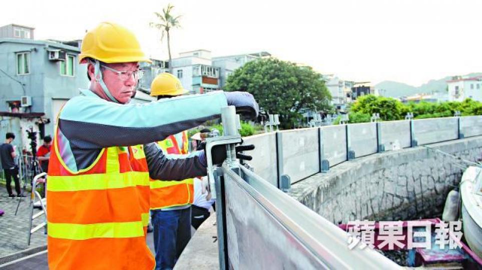 渠務署人員昨在大澳河堤加裝擋水板。 渠務署人員昨在大澳河堤加裝擋水板。