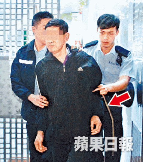 警方拘捕涉嫌虐兒的父親,並撿走一支藤條(箭嘴示)。唐家輝攝 警方拘捕涉嫌虐兒的父親,並撿走一支藤條(箭嘴示)。唐家輝攝