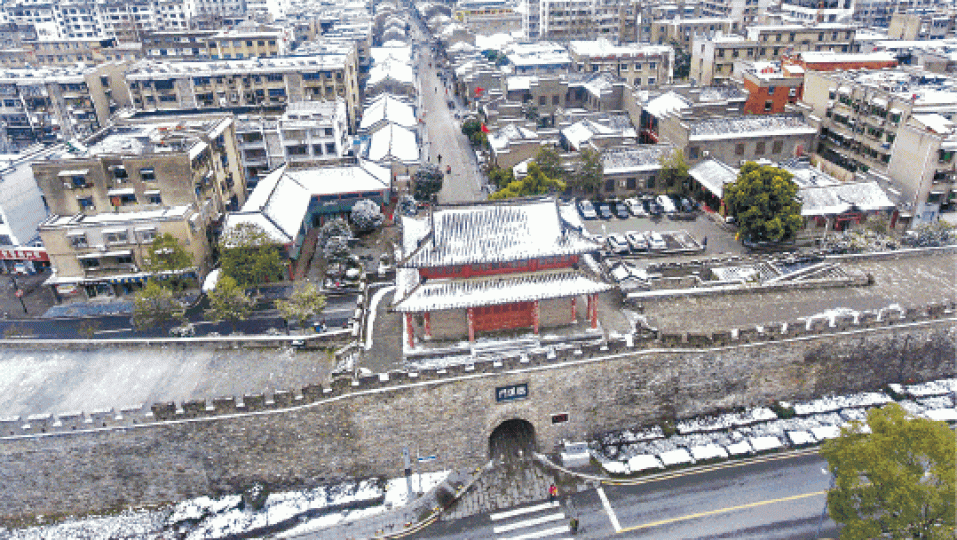 湖北襄陽古城昨飄雪。台近年關降溫急凍,民眾外出都穿厚衣。 湖北襄陽古城昨飄雪。台近年關降溫急凍,民眾外出都穿厚衣。