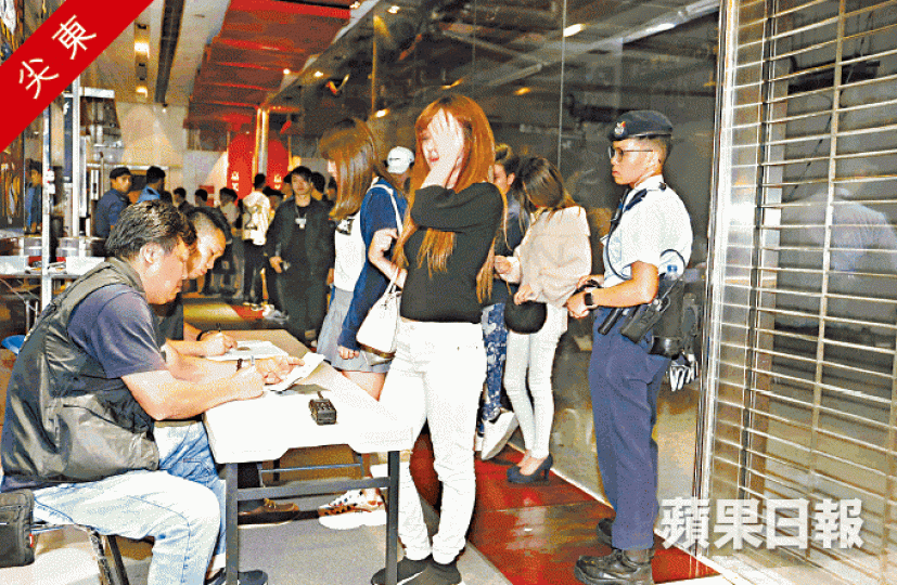 探員在一幢夜場林立的大廈登記出入人士資料。黃江奇攝
