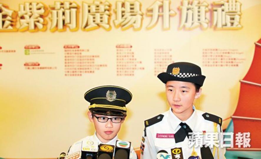 福建中學附屬學校的張同學（右）說：「我哋對呢樣嘢唔太清楚，暫時未能作答。」身旁的黃同學對於能到場觀禮表示「感恩」。保良局林文燦英文小學的小六生黃同學（左）及陳同學（右）說：「第一次世界大戰之後，戰敗國德國將山東省轉讓畀日本，係青年愛國嘅……」