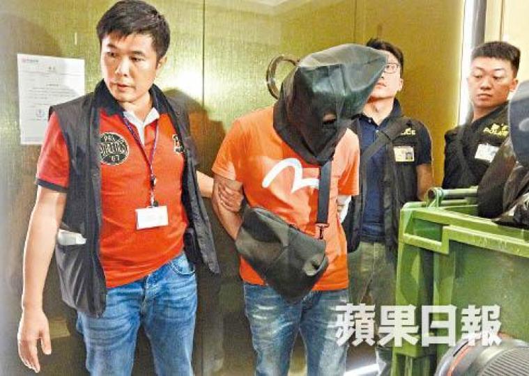 38歲姓譚主腦昨被蒙頭帶署。